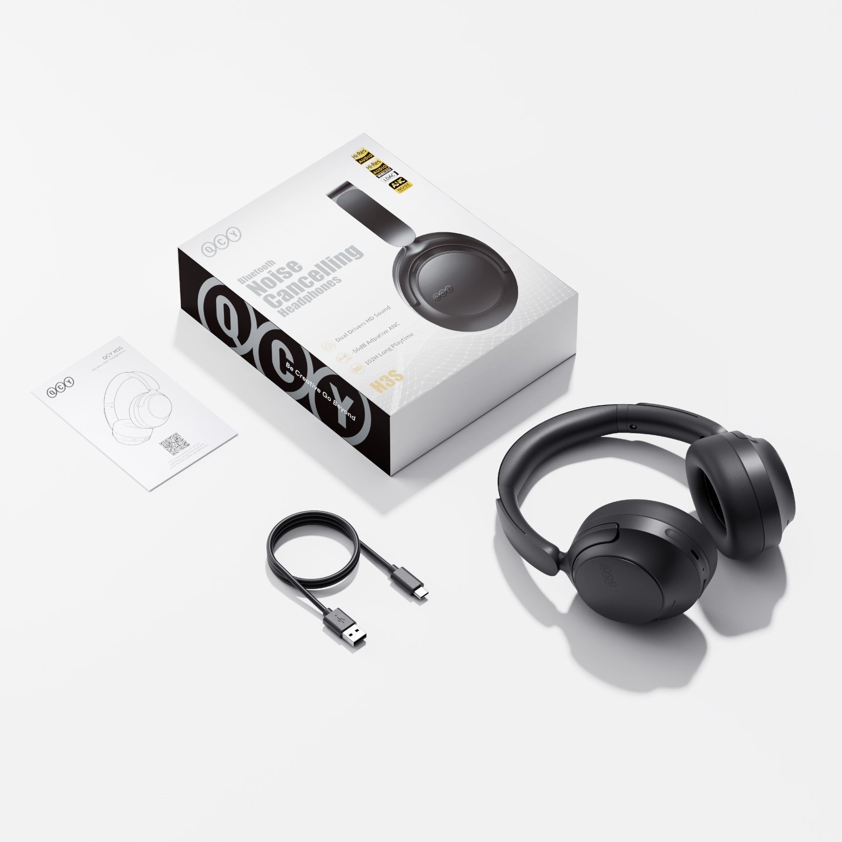 Auriculares QCY H3S Bluetooth com cancelamento de ruído, pretos, com cabo de carregamento USB-C e manual.